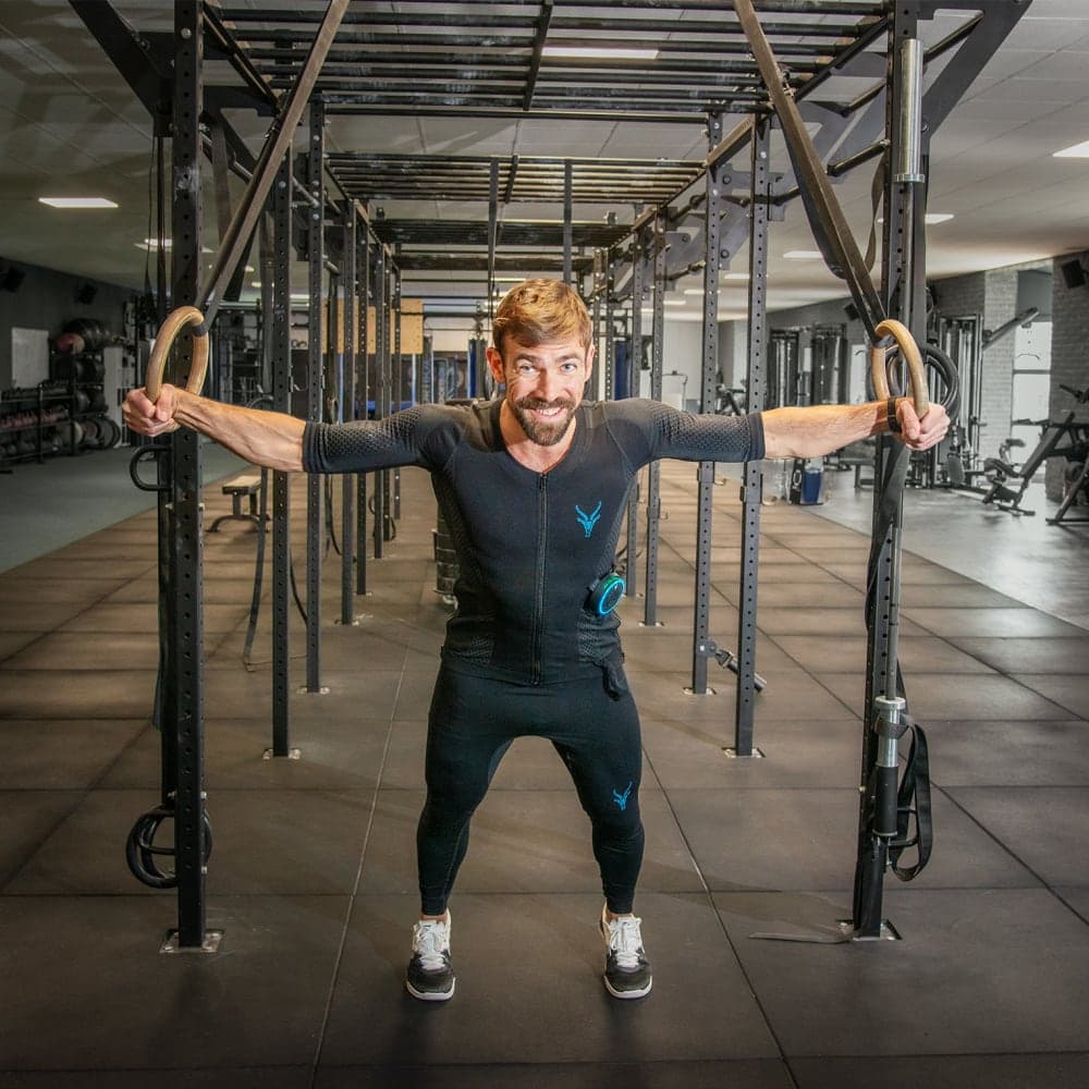 Ein Mann führt ein Krafttraining mit dem EMS Anzug von Antelope in einem Fitnessstudio durch.